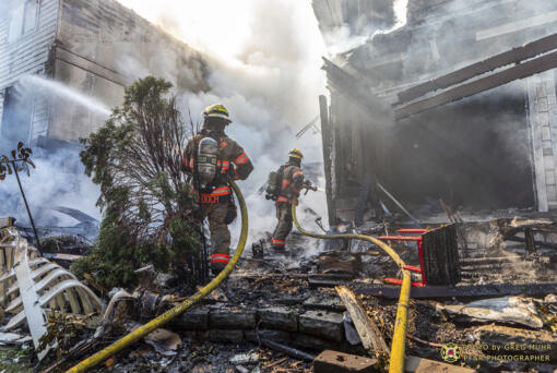 In this photo provided by Portland Fire &amp; Rescue, firefighters use handlines to extinguish the fire adjacent to the primary structure involved after a small plane crashed Saturday, Aug. 31, 2024, in Fairview, Ore.