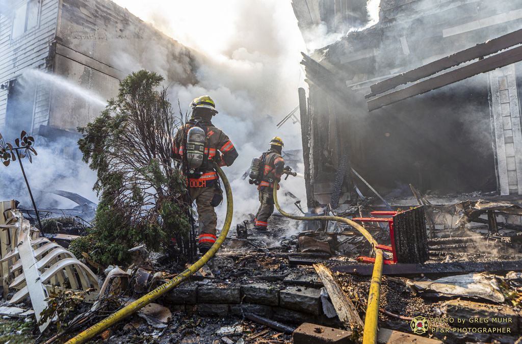 In this photo provided by Portland Fire &amp; Rescue, firefighters use handlines to extinguish the fire adjacent to the primary structure involved after a small plane crashed Saturday, Aug. 31, 2024, in Fairview, Ore.