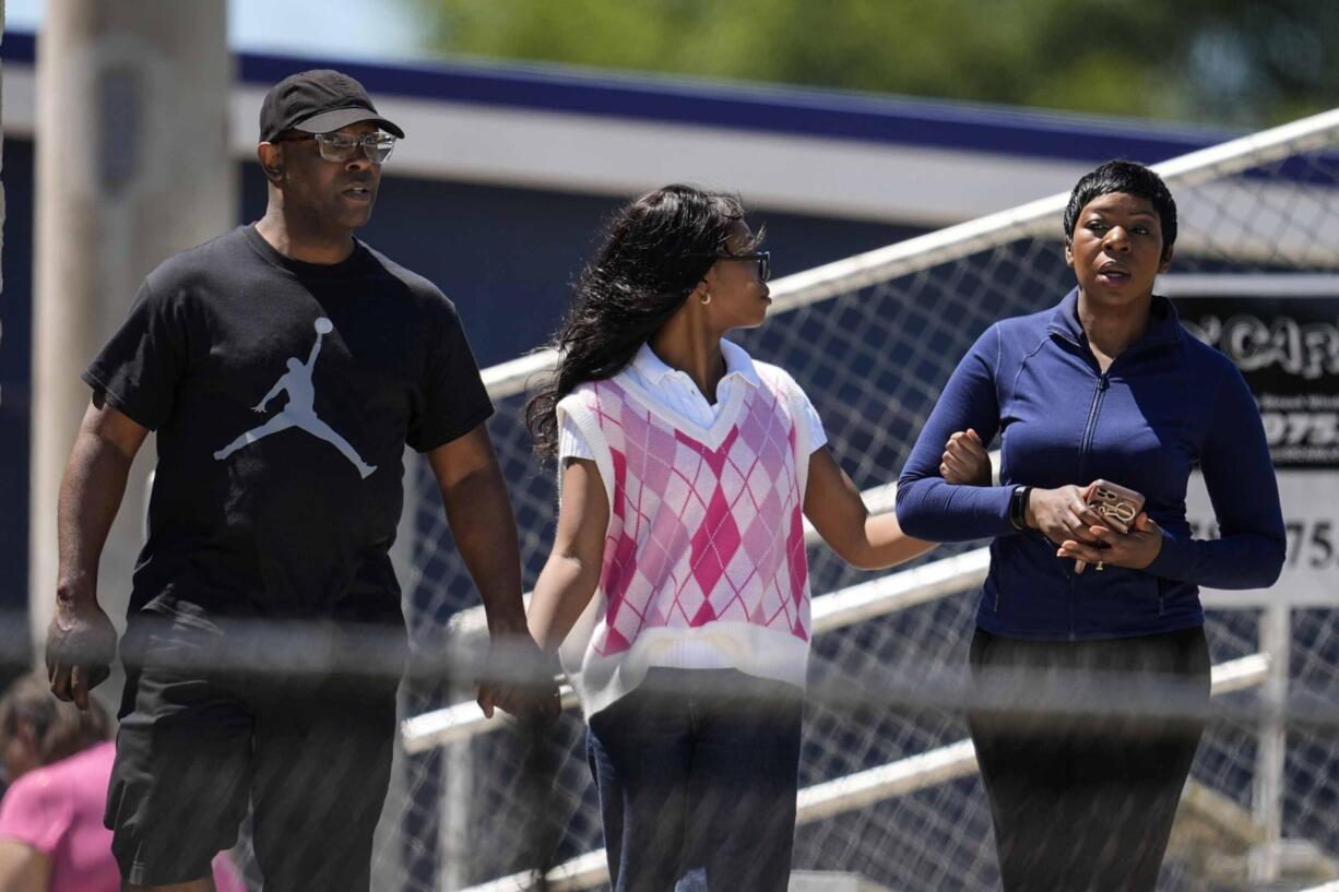 Parents walk their child out of Apalachee High School after a shooting at the school Wednesday, Sept. 4, 2024, in Winder, Ga.