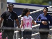 Parents walk their child out of Apalachee High School after a shooting at the school Wednesday, Sept. 4, 2024, in Winder, Ga.