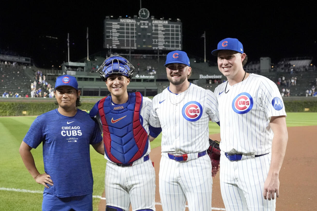 Chicago Cubs, from left, starting pitcher Shota Imanaga, catcher Miguel Amaya, and relief pitchers Porter Hodge and Nate Pearson, pose for a photo after they had a combined no-hitter against the Pittsburgh Pirates in the team's 12-0 win in a baseball game Wednesday, Sept. 4, 2024, in Chicago.