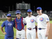 Chicago Cubs, from left, starting pitcher Shota Imanaga, catcher Miguel Amaya, and relief pitchers Porter Hodge and Nate Pearson, pose for a photo after they had a combined no-hitter against the Pittsburgh Pirates in the team's 12-0 win in a baseball game Wednesday, Sept. 4, 2024, in Chicago.