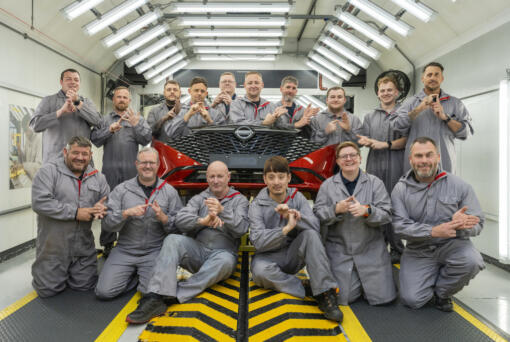 In this photo provided by Nissan on Thursday, Sept. 5, 2024, workers of Nissan's plant’s Paint Shop including John Johnson, foreground right and Michael Connolly, foreground, second left, pose for a photo at the plant, in Sunderland, England.