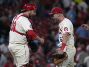 St. Louis Cardinals' Pedro Pages, left, and teammate Michael Siani celebrate a 2-0 victory over the Seattle Mariners in a baseball game Saturday, Sept. 7, 2024, in St. Louis.