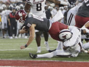 Washington State quarterback John Mateer (10) reaches for a touchdown while pressured by Texas Tech defensive back A.J. McCarty (1) during the first half of an NCAA college football game, Saturday, Sept. 7, 2024, in Pullman, Wash.