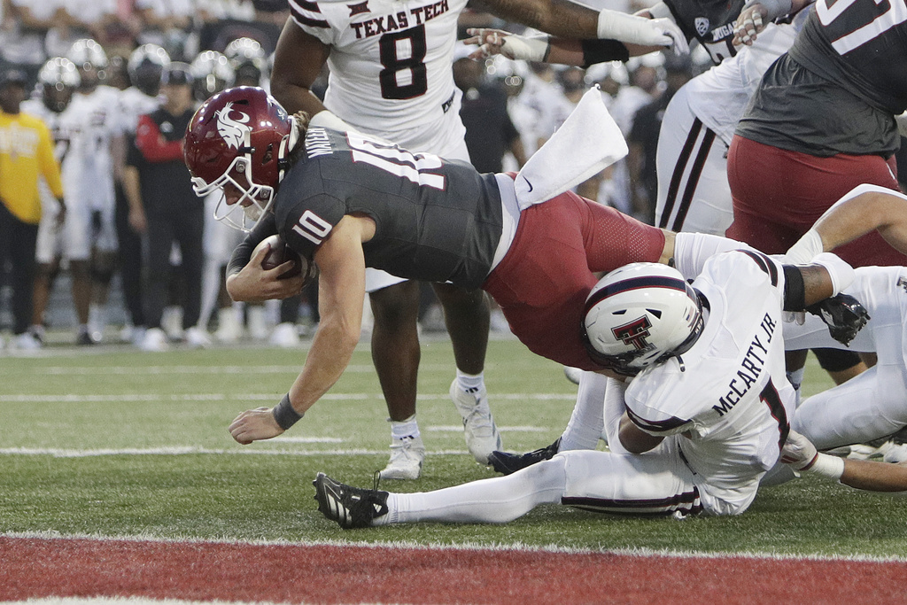 Washington State quarterback John Mateer (10) reaches for a touchdown while pressured by Texas Tech defensive back A.J. McCarty (1) during the first half of an NCAA college football game, Saturday, Sept. 7, 2024, in Pullman, Wash.