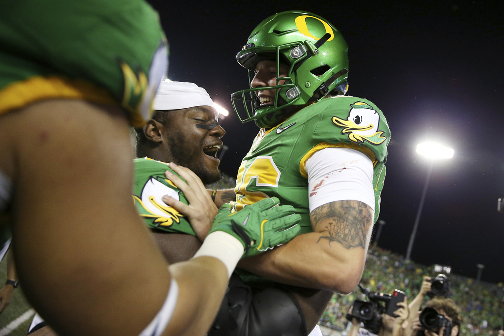 Oregon place kicker Atticus Sappington (36) is congratulated by teammates after his game-winning field goal after an NCAA college football game against Boise State, Saturday, Sept. 7, 2024, at Autzen Stadium in Eugene, Ore.