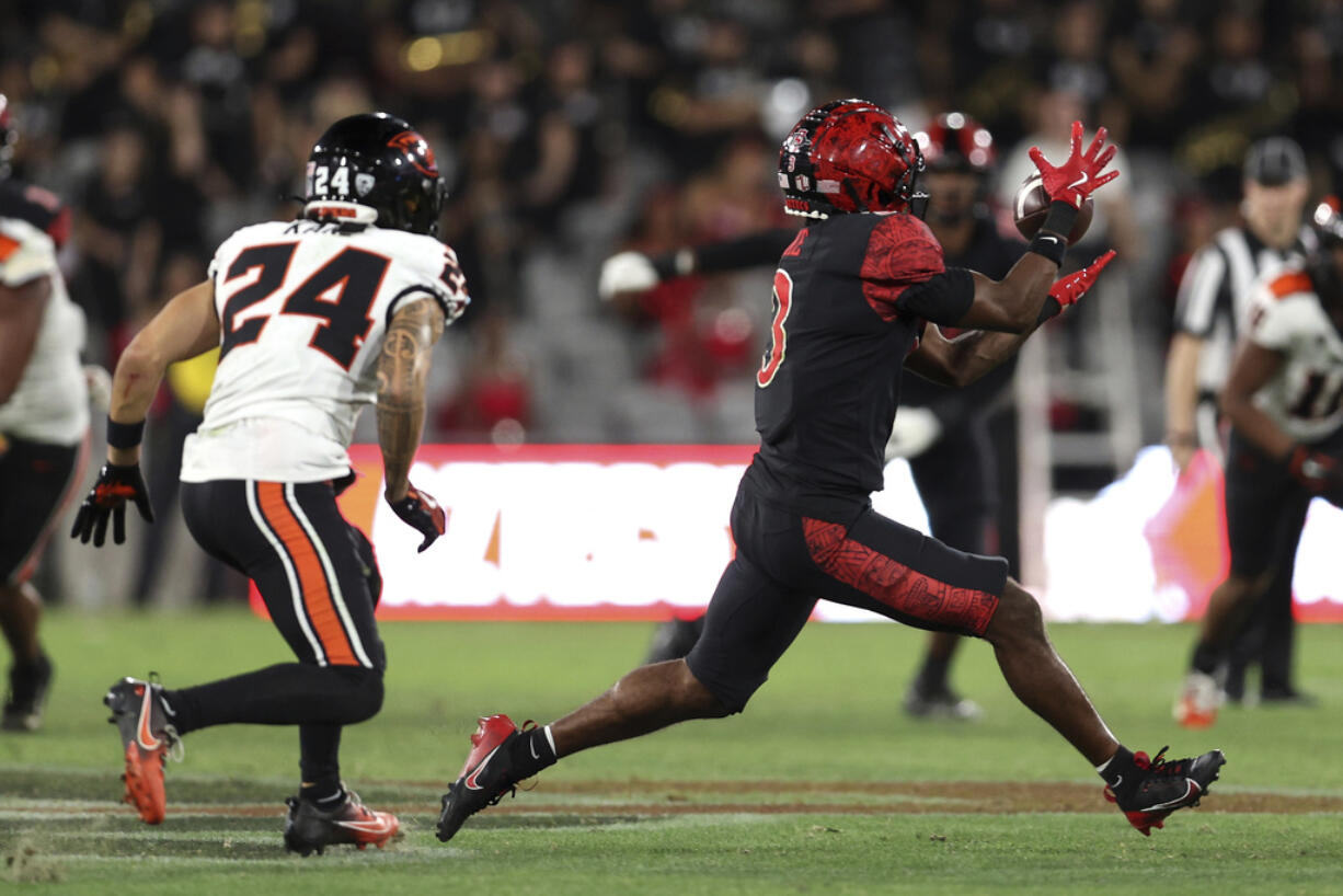 San Diego State wide receiver Ja'Shaun Poke, right, catches the ball chased by Oregon State defensive back Jack Kane (24) during the second half of an NCAA college football game Saturday, Sept. 7, 2024, in San Diego.