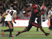 San Diego State wide receiver Ja'Shaun Poke, right, catches the ball chased by Oregon State defensive back Jack Kane (24) during the second half of an NCAA college football game Saturday, Sept. 7, 2024, in San Diego.