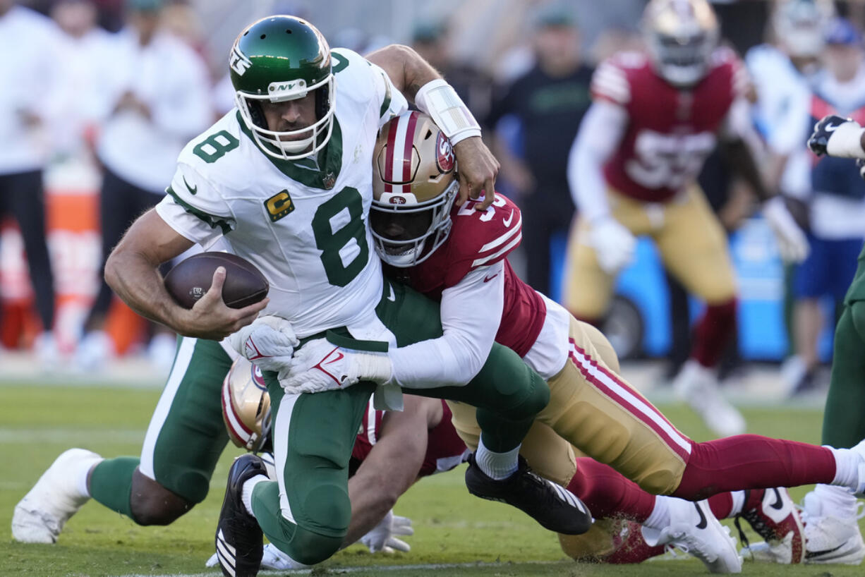 New York Jets quarterback Aaron Rodgers (8) is sacked by San Francisco 49ers defensive end Leonard Floyd during the first half of an NFL football game in Santa Clara, Calif., Monday, Sept. 9, 2024. (AP Photo/Godofredo A.