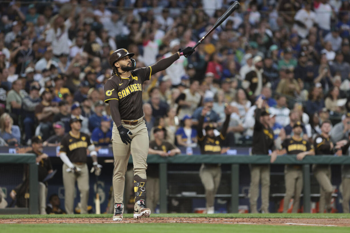 San Diego Padres' Fernando Tatis Jr. follows through after hitting a three-run home run off Seattle Mariners starting pitcher George Kirby to score Donovan Solano and Luis Arraez during the third inning of a baseball game, Tuesday, Sept. 10, 2024, in Seattle.