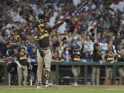 San Diego Padres' Fernando Tatis Jr. follows through after hitting a three-run home run off Seattle Mariners starting pitcher George Kirby to score Donovan Solano and Luis Arraez during the third inning of a baseball game, Tuesday, Sept. 10, 2024, in Seattle.