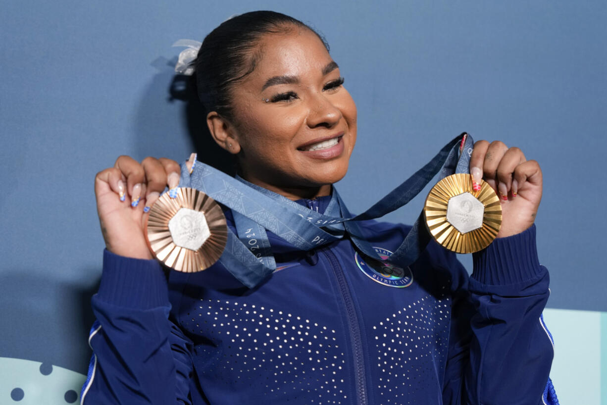 Vancouver's Jordan Chiles, of the United States, holds up her medals after the women's artistic gymnastics individual apparatus finals Bercy Arena at the 2024 Summer Olympics, Aug. 5, 2024, in Paris, France.