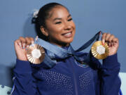 Vancouver's Jordan Chiles, of the United States, holds up her medals after the women's artistic gymnastics individual apparatus finals Bercy Arena at the 2024 Summer Olympics, Aug. 5, 2024, in Paris, France.