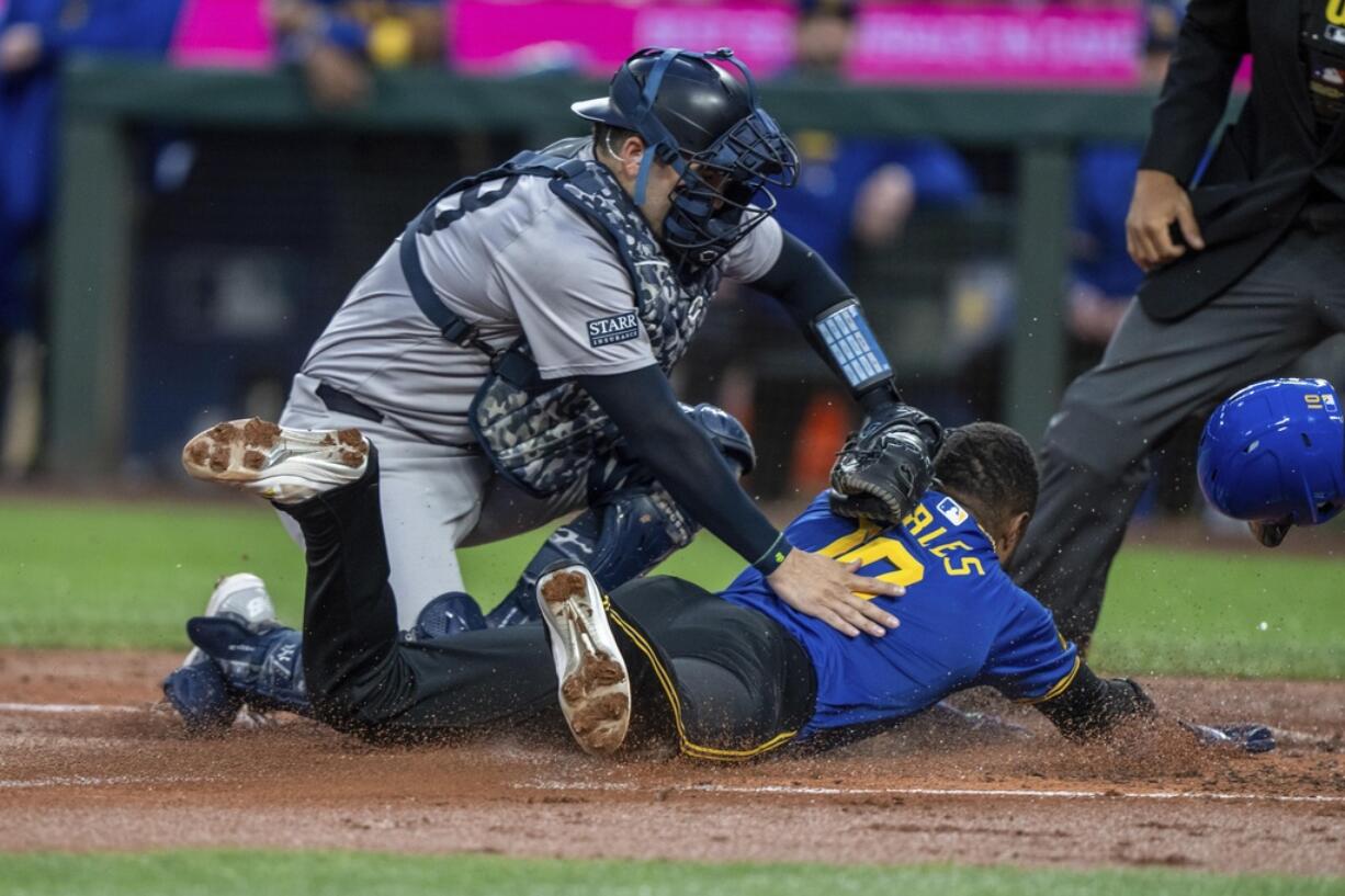 New York Yankees catcher Austin Wells tags out Seattle Mariners' Victor Robles attempting to steal home plate during the first inning of a baseball game, Tuesday, Sept. 17, 2024, in Seattle.