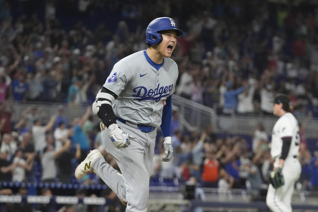 Los Angeles Dodgers' Shohei Ohtani (17) reacts after hitting his 50th home run of the season during the seventh inning of a baseball game against the Miami Marlins, Thursday, Sept. 19, 2024, in Miami.