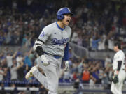 Los Angeles Dodgers' Shohei Ohtani (17) reacts after hitting his 50th home run of the season during the seventh inning of a baseball game against the Miami Marlins, Thursday, Sept. 19, 2024, in Miami.