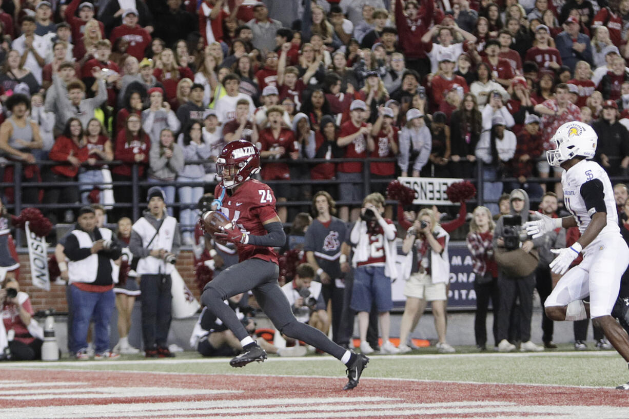 Washington State defensive back Ethan O'Connor (24) secures an intercepted San Jose State pass during overtime in an NCAA college football game, Friday, Sept. 20, 2024, in Pullman, Wash.