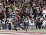 Washington State defensive back Ethan O'Connor (24) secures an intercepted San Jose State pass during overtime in an NCAA college football game, Friday, Sept. 20, 2024, in Pullman, Wash.