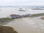 This photo provided by the state company Polish Waters shows the Oder River flood waters channelled into and contained by the newly-built Lower Raciborz Reservoir that has spared the cities of Opole and Wroclaw from flooding, in Raciborz, southwestern Poland, Sept. 16, 2024.