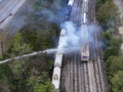 Firefighters work on the scene of a chemical leak in railcars near Cleves, Ohio, Tuesday, Sept. 24, 2024.