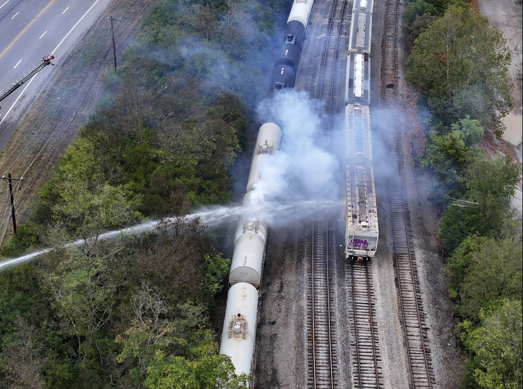 Firefighters work on the scene of a chemical leak in railcars near Cleves, Ohio, Tuesday, Sept. 24, 2024.