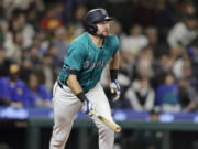 Seattle Mariners' Cal Raleigh watches the flight of his solo home run off Oakland Athletics starting pitcher Joey Estes during the fourth inning in a baseball game, Saturday, Sept. 28, 2024, in Seattle.