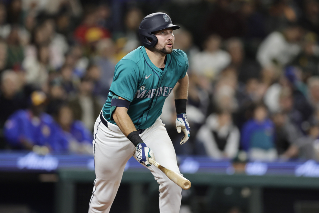 Seattle Mariners' Cal Raleigh watches the flight of his solo home run off Oakland Athletics starting pitcher Joey Estes during the fourth inning in a baseball game, Saturday, Sept. 28, 2024, in Seattle.