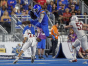 Boise State running back Ashton Jeanty (2) hurdles Washington State defensive back Ethan O'Connor (24) on a run in the second quarter of an NCAA college football game, Saturday, Sept. 28, 2024, in Boise, Idaho.