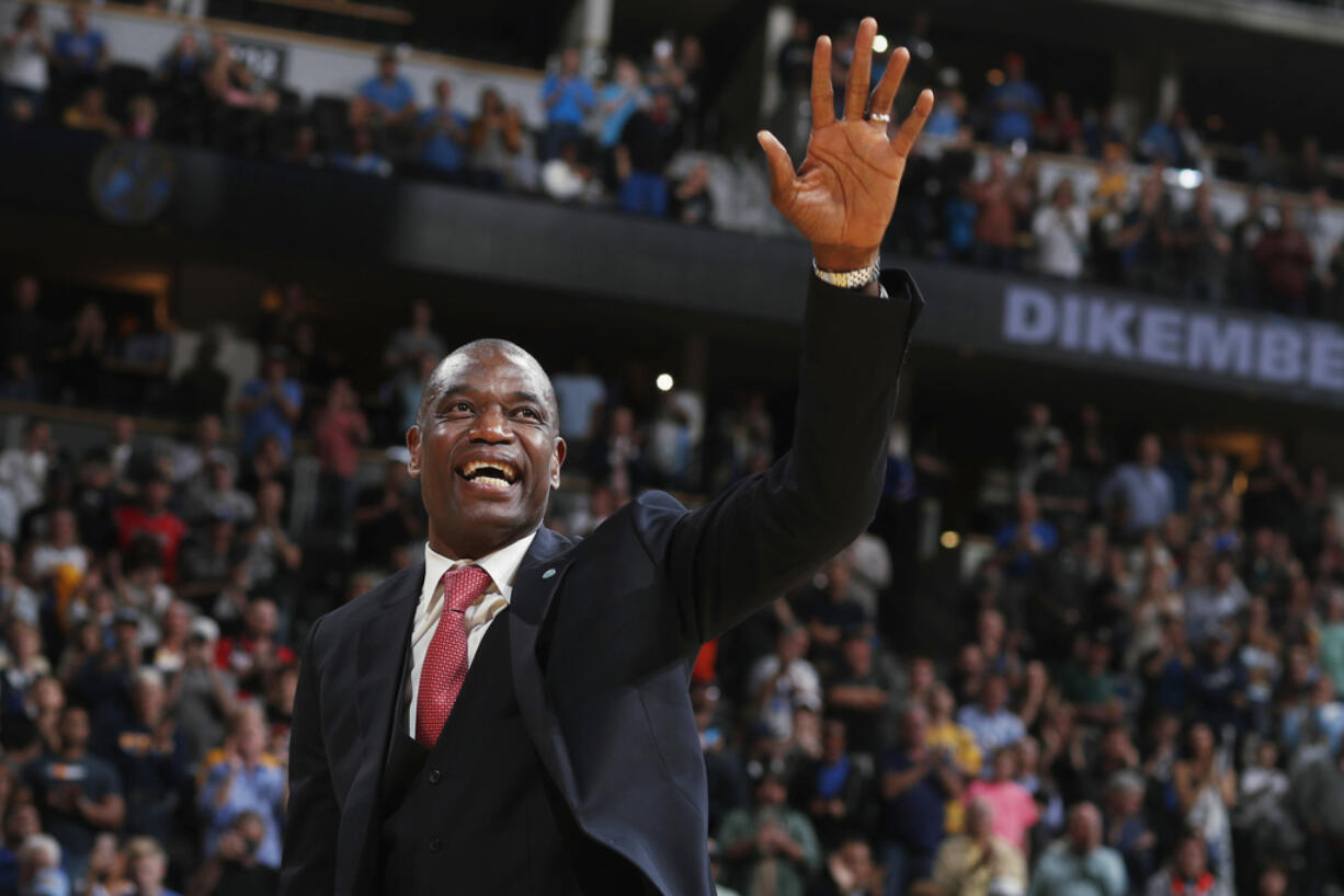 FILE - Retired Denver Nuggets center Dikembe Mutombo waves to the crowd as his jersey number was retired by the team during halftime of the Nuggets' NBA basketball game against the Portland Trail Blazers on Saturday, Oct. 29, 2016, in Denver.