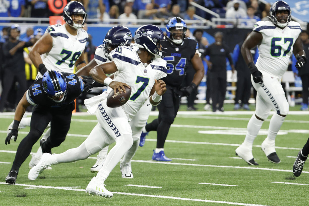 Seattle Seahawks quarterback Geno Smith (7) rushes against the Detroit Lions in the first half of an NFL football game in Detroit, Monday, Sept. 30, 2024.