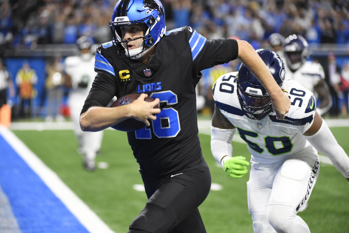 Detroit Lions quarterback Jared Goff runs after a 7-yard reception for a touchdown during the second half of an NFL football game against the Seattle Seahawks, Monday, Sept. 30, 2024, in Detroit.