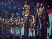 Taylor Swift, center, and Post Malone, third from back left, accept the video of the year award for &quot;Fortnight&quot; during the MTV Video Music Awards on Wednesday, Sept. 11, 2024, at UBS Arena in Elmont, N.Y. Host Megan Thee Stallion, from far left back, Rodrigo Prieto, and Ethan Tobman, far right, look on.