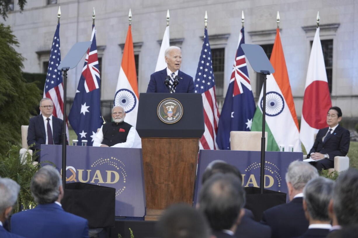 President Joe Biden, center &mdash; joined by Australian Prime Minister Anthony Albanese, Indian Prime Minister Narendra Modi and Japanese Prime Minister Fumio Kishida &mdash; speaks Saturday during a Quad leaders&rsquo; summit at Archmere Academy in Claymont, Del.