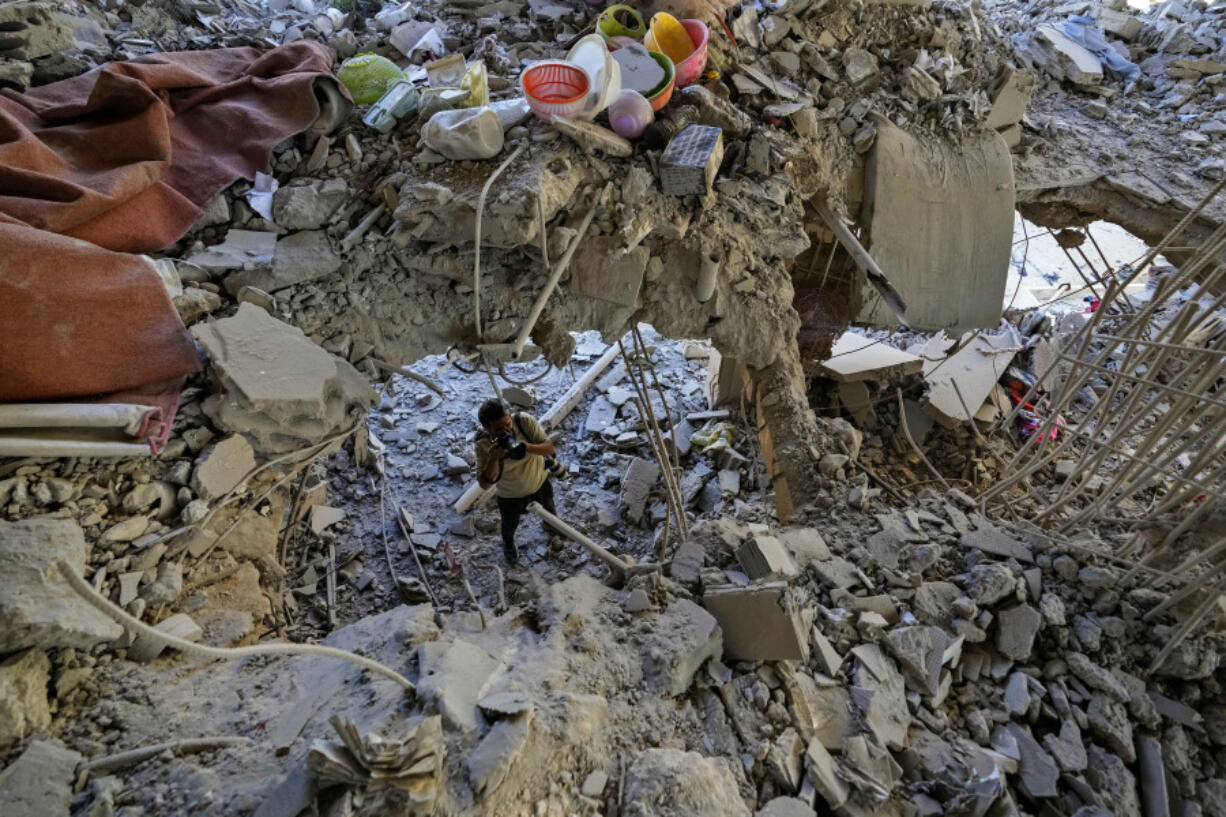 A photographer documents damage in a building that was hit by an Israeli airstrike in Beirut&rsquo;s southern suburb, Lebanon, Monday, Sept. 30, 2024.