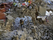 A photographer documents damage in a building that was hit by an Israeli airstrike in Beirut&rsquo;s southern suburb, Lebanon, Monday, Sept. 30, 2024.