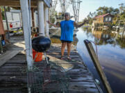 Debra Matherne describes her experience as she rode out Hurricane Francine the previous night, along Bayou Pointe-au-Chien, La., Thursday, Sept. 12, 2024.