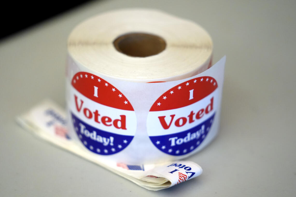 A spool of stickers rests on a table at a polling station during Massachusetts state primary voting, Sept. 3, 2024, in Newton, Mass.