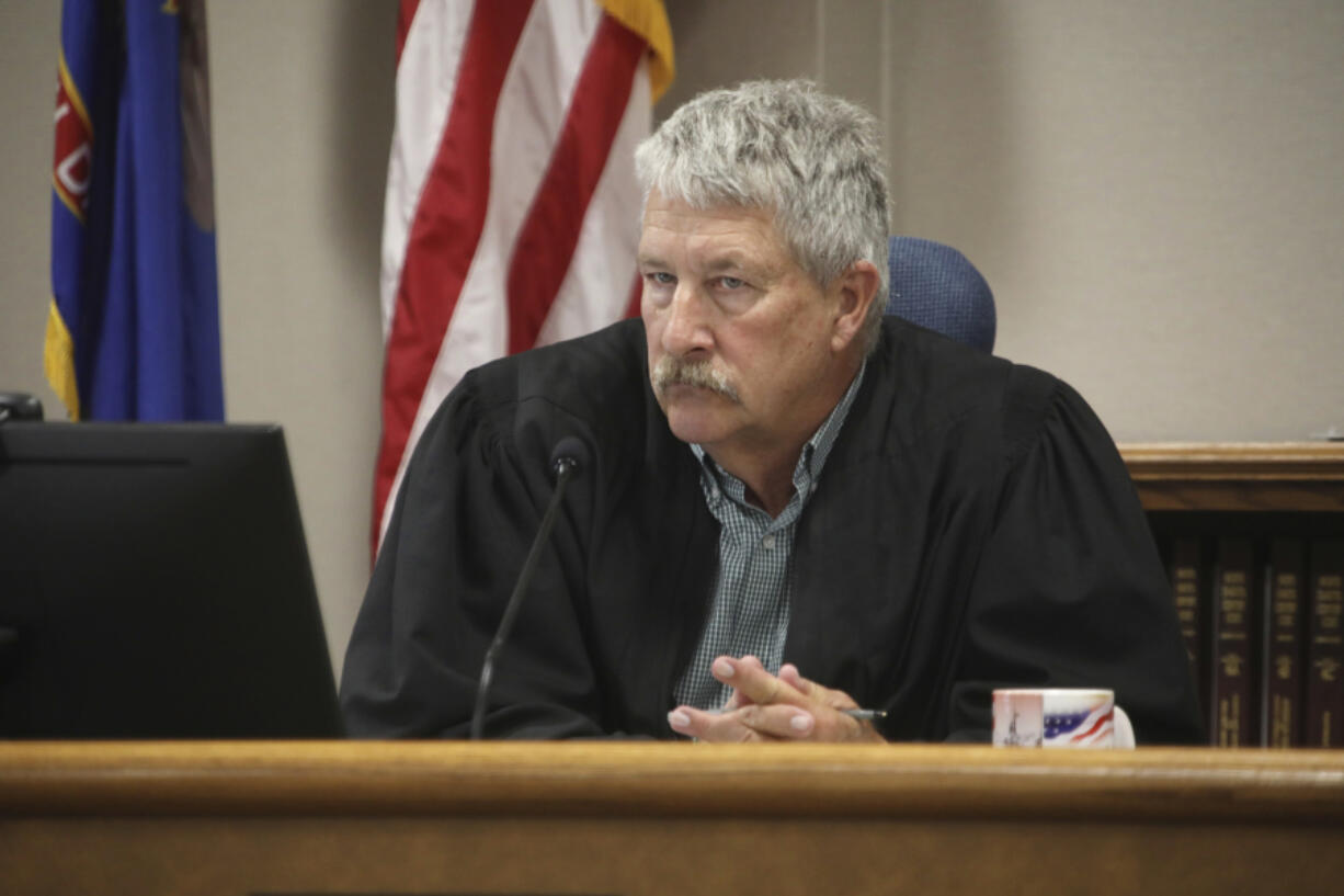 FILE - South Central District Judge Bruce Romanick listens to arguments by attorneys during a hearing challenging North Dakota&#039;s abortion laws, July 23, 2024, in Bismarck, N.D.