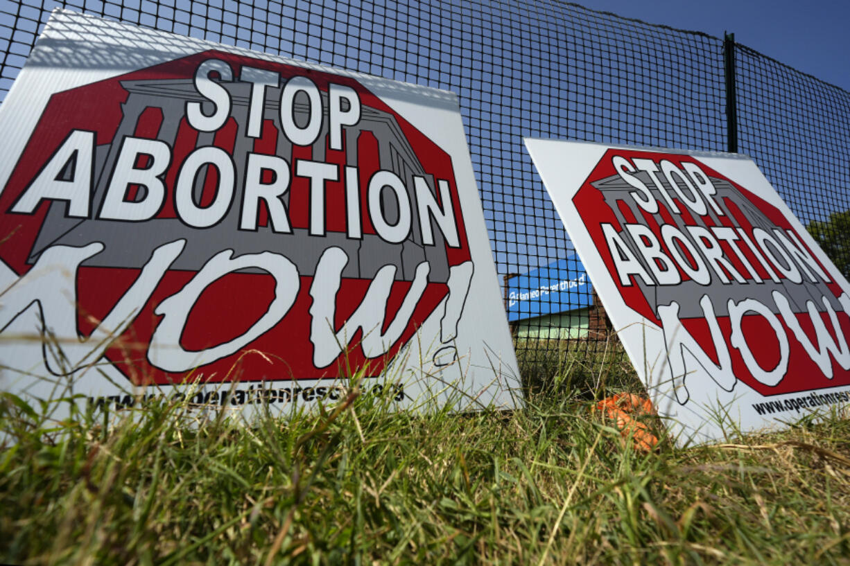 Anti-abortion signs lean against a fence outside a recently opened Planned Parenthood clinic in Pittsburg, Kan., on Sept. 10.