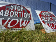 Anti-abortion signs lean against a fence outside a recently opened Planned Parenthood clinic in Pittsburg, Kan., on Sept. 10.