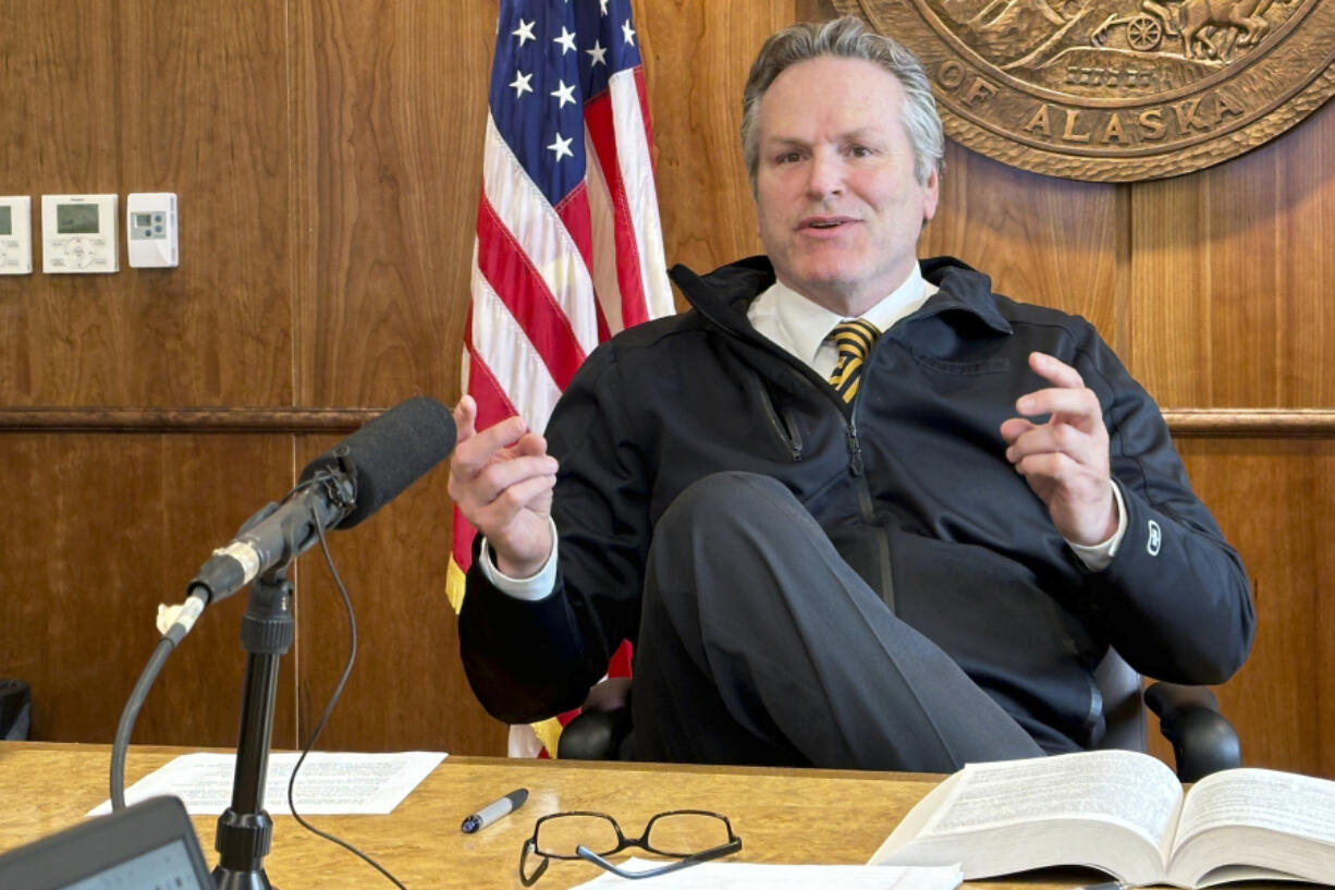 FILE - Alaska Gov. Mike Dunleavy gestures while speaking with reporters on May 1, 2024, in Juneau, Alaska.