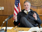 FILE - Alaska Gov. Mike Dunleavy gestures while speaking with reporters on May 1, 2024, in Juneau, Alaska.