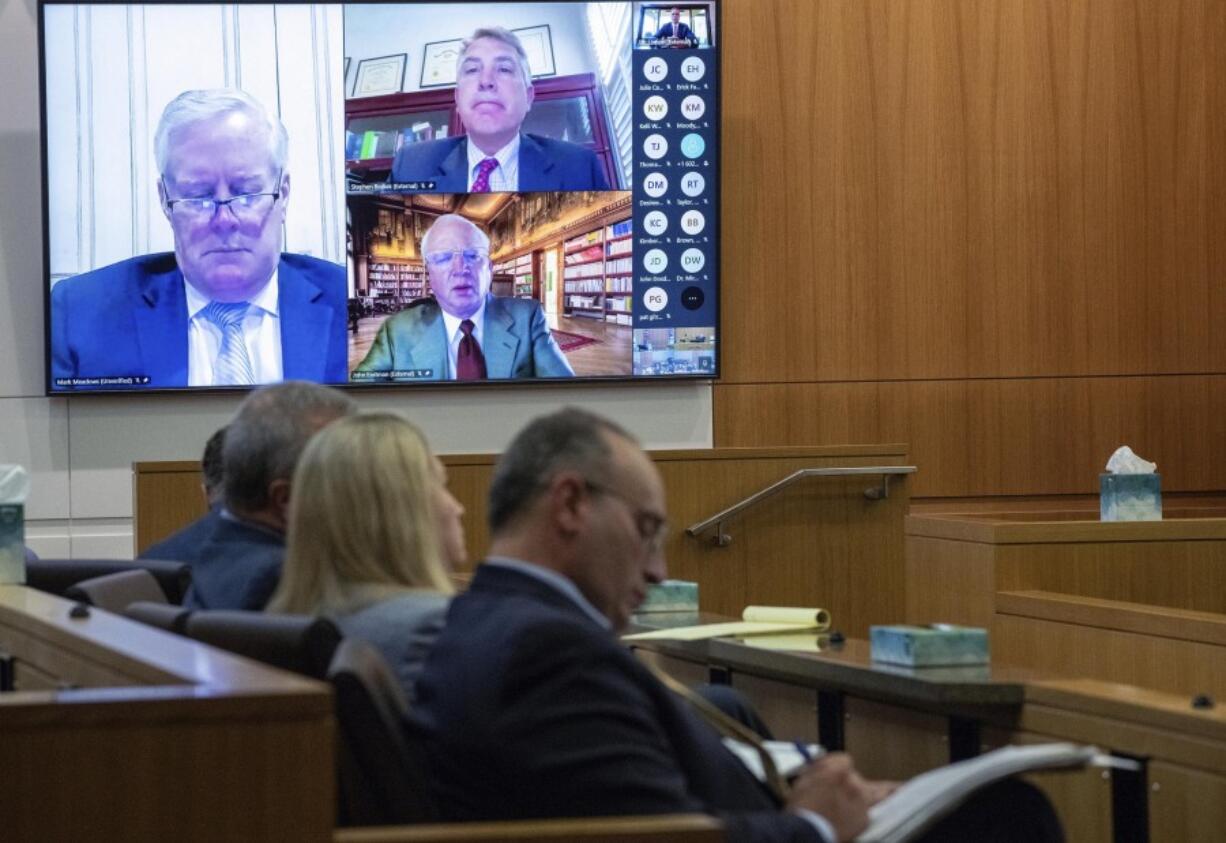 Mark Meadows, left, Stephen Binhak and Jim Eastman appear virtually during a pre-trial hearing in the fake electors case in Maricopa County Superior Court on Wednesday, Aug 28, 2024, in Phoenix.