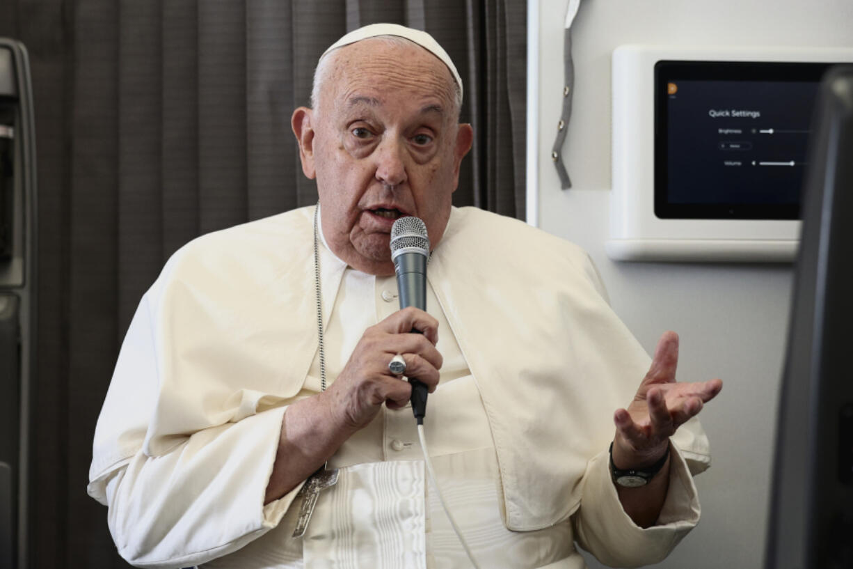 Pope Francis holds a news conference aboard the papal plane on his flight back after his 11-day journey across Southeast Asia and Oceania, Friday, Sept. 13, 2024. Francis went rogue plenty of times in Asia, and at the in-flight press conference coming back to Rome, he urged American Catholics to vote for who they thought was the &quot;lesser evil&quot; for president.