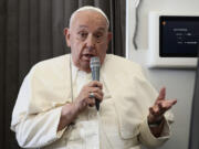 Pope Francis holds a news conference aboard the papal plane on his flight back after his 11-day journey across Southeast Asia and Oceania, Friday, Sept. 13, 2024. Francis went rogue plenty of times in Asia, and at the in-flight press conference coming back to Rome, he urged American Catholics to vote for who they thought was the &quot;lesser evil&quot; for president.