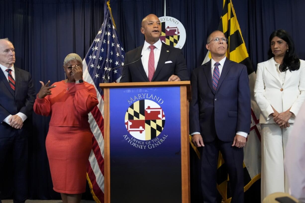 Maryland Gov. Wes Moore, center, speaks during a news conference announcing a lawsuit seeking damages from the owners and managers of the Dali cargo ship that crashed into the Francis Key Scott Bridge, Tuesday, Sept. 24, 2024, in Baltimore.