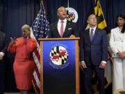 Maryland Gov. Wes Moore, center, speaks during a news conference announcing a lawsuit seeking damages from the owners and managers of the Dali cargo ship that crashed into the Francis Key Scott Bridge, Tuesday, Sept. 24, 2024, in Baltimore.