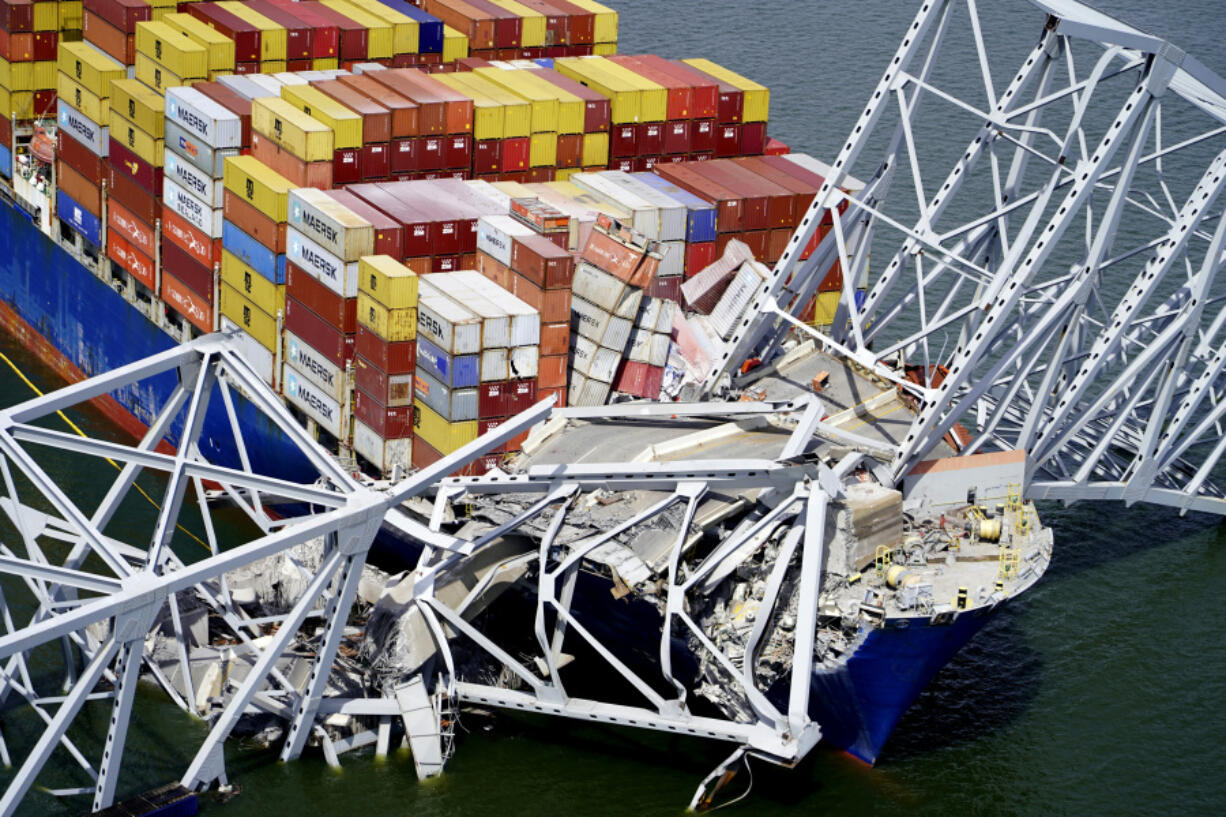 FILE - In this aerial image released by the Maryland National Guard, the cargo ship Dali is stuck under part of the structure of the Francis Scott Key Bridge after the ship hit the bridge, March 26, 2024, in Baltimore.