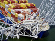 FILE - In this aerial image released by the Maryland National Guard, the cargo ship Dali is stuck under part of the structure of the Francis Scott Key Bridge after the ship hit the bridge, March 26, 2024, in Baltimore.